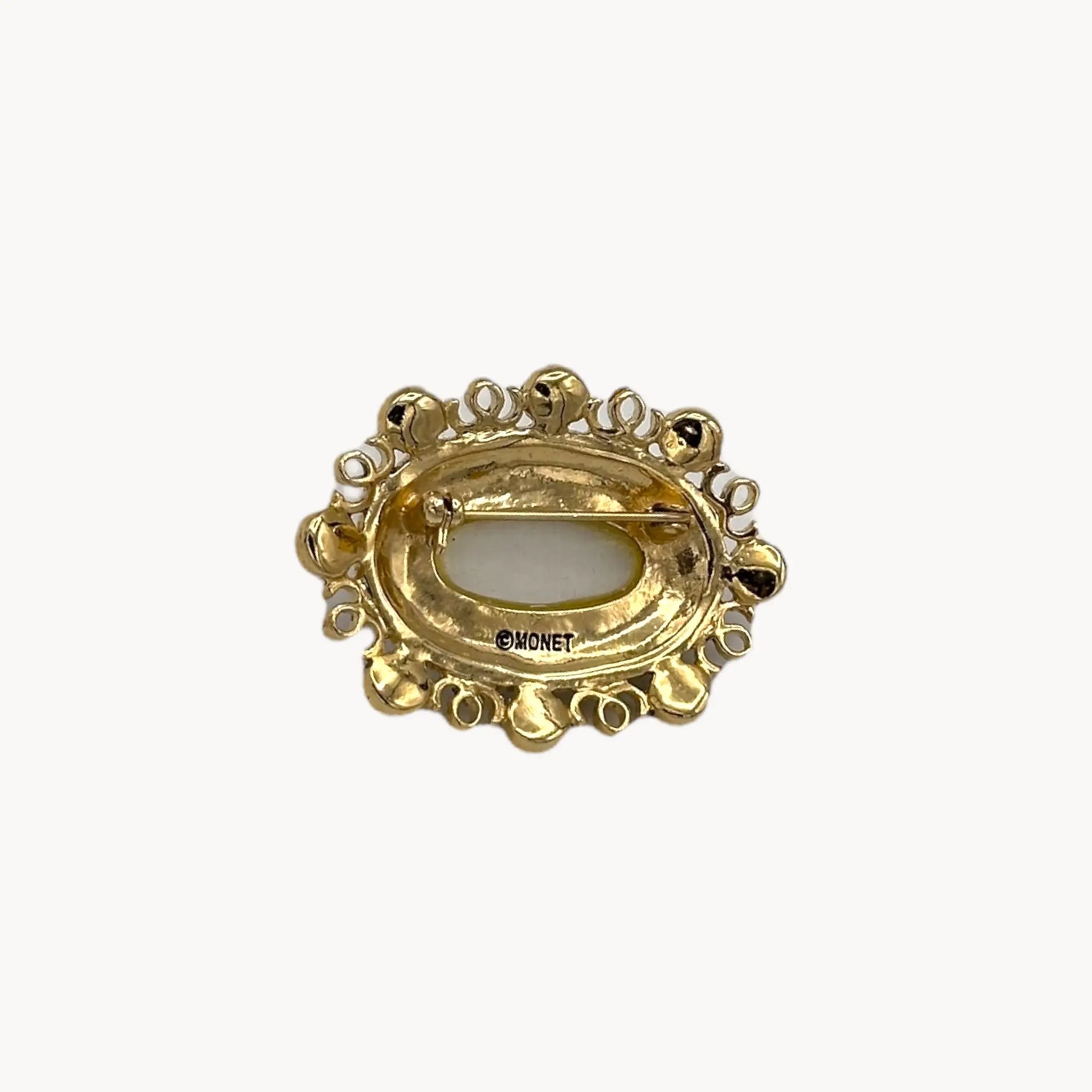 Back view Vintage Monet oval brooch with faceted glass center, faux pearls, and crystal accents.