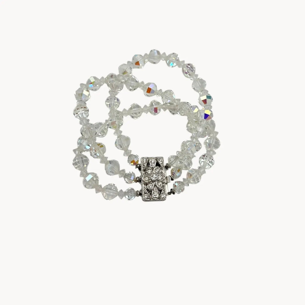 Against a white background Vintage unsigned multi-strand faceted crystal bracelet with rhinestone clasp in Art Deco style.