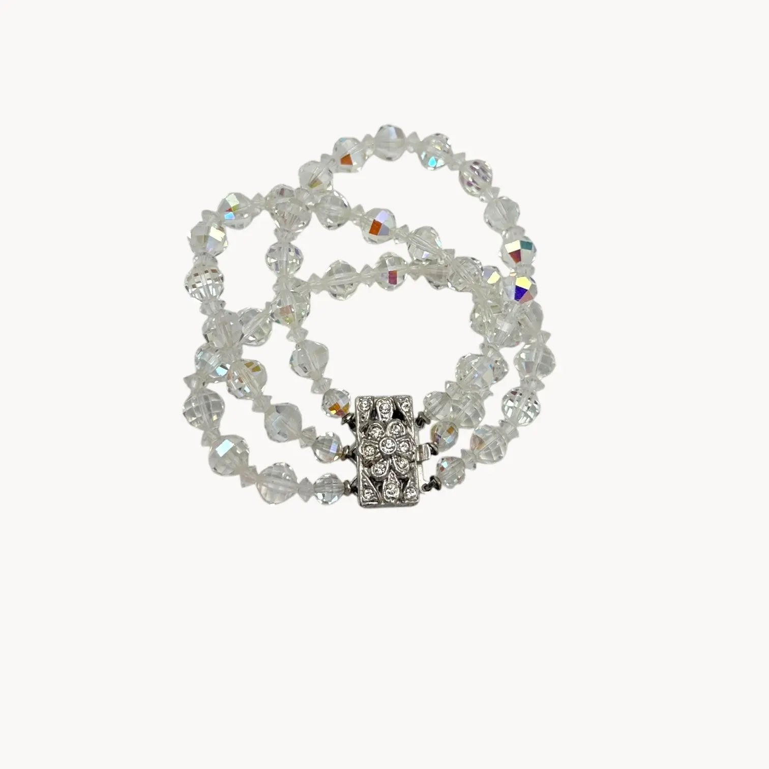 Against a white background Vintage unsigned multi-strand faceted crystal bracelet with rhinestone clasp in Art Deco style.