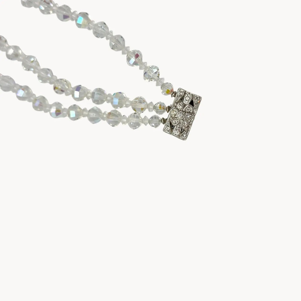 Close up view of clasp of Vintage unsigned multi-strand faceted crystal bracelet with rhinestone clasp in Art Deco style.