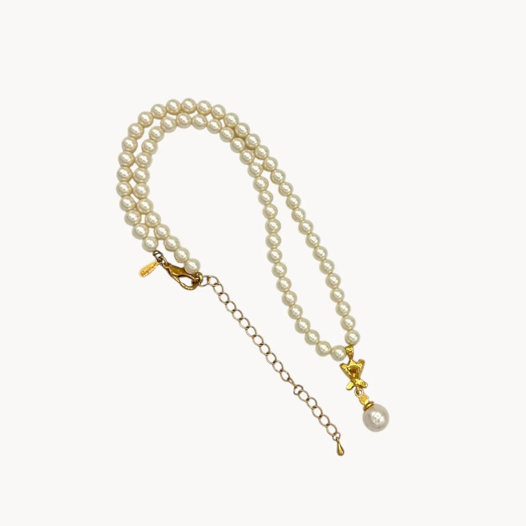 Back view of Vintage Napier faux pearl necklace with rhinestone X motif and pearl drop pendant.