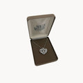 Vintage Nolan Miller rhinestone heart pendant necklace on silver chain in original box.
