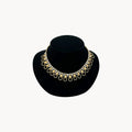 Vintage Sarah Coventry gold-tone teardrop bib necklace with clear rhinestones displayed on black velvet bust.