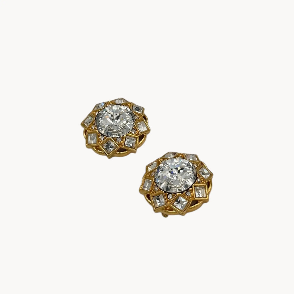 Side view of Vintage St. John clip-on earrings with round crystal centers and square-cut crystal frame in gold-tone setting, bridal jewelry.