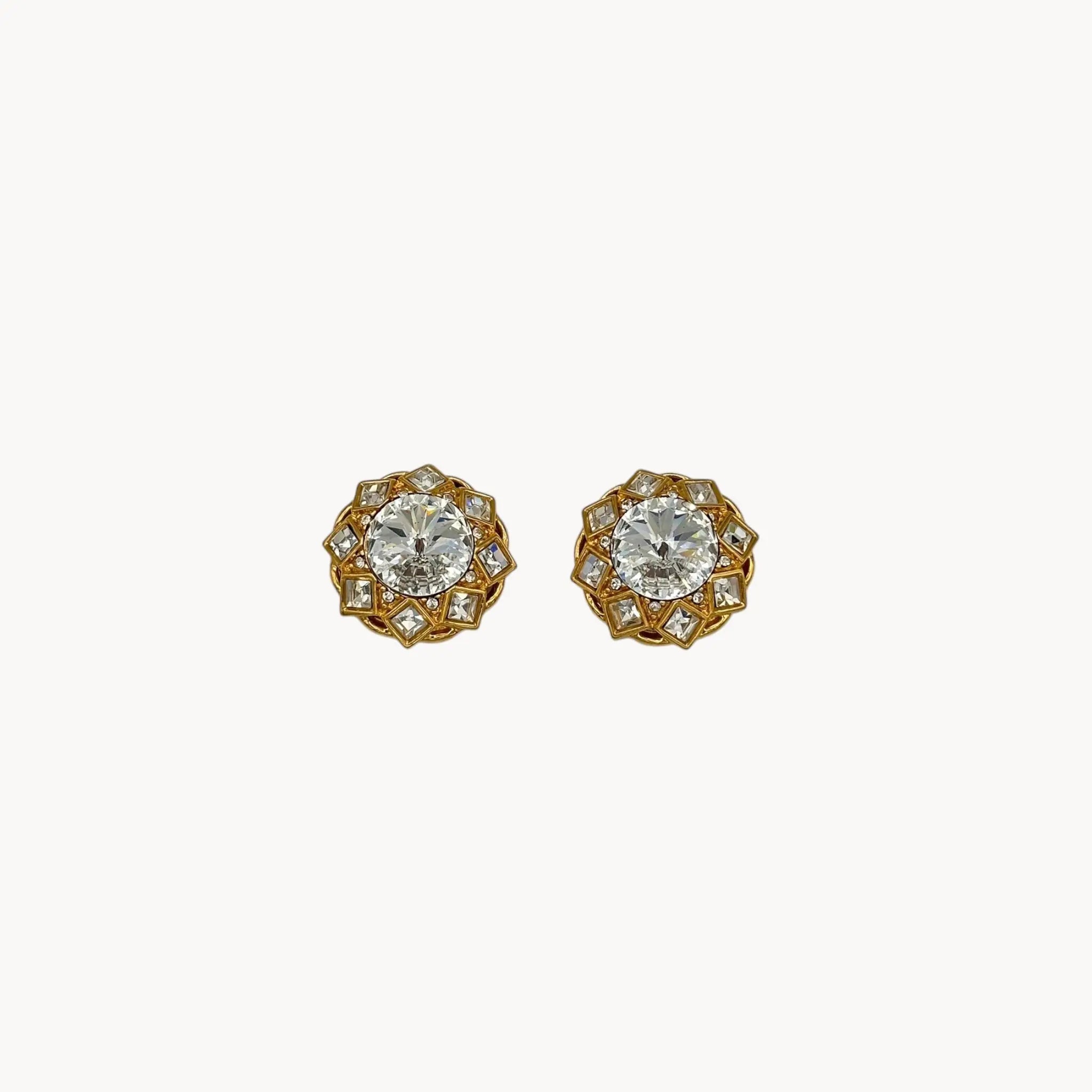 Close up front view of Vintage St. John clip-on earrings with round crystal centers and square-cut crystal frame in gold-tone setting, bridal jewelry.