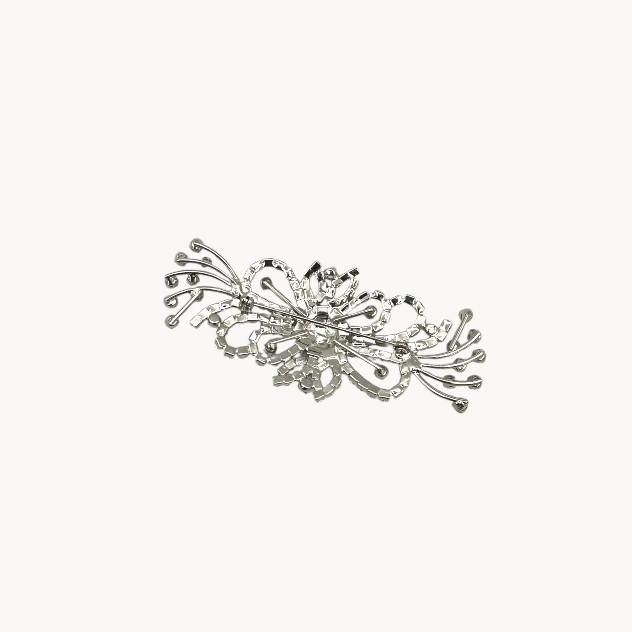Back view of Large vintage rhinestone spray brooch with prong-set stones and rhodium plating, mid-century design.