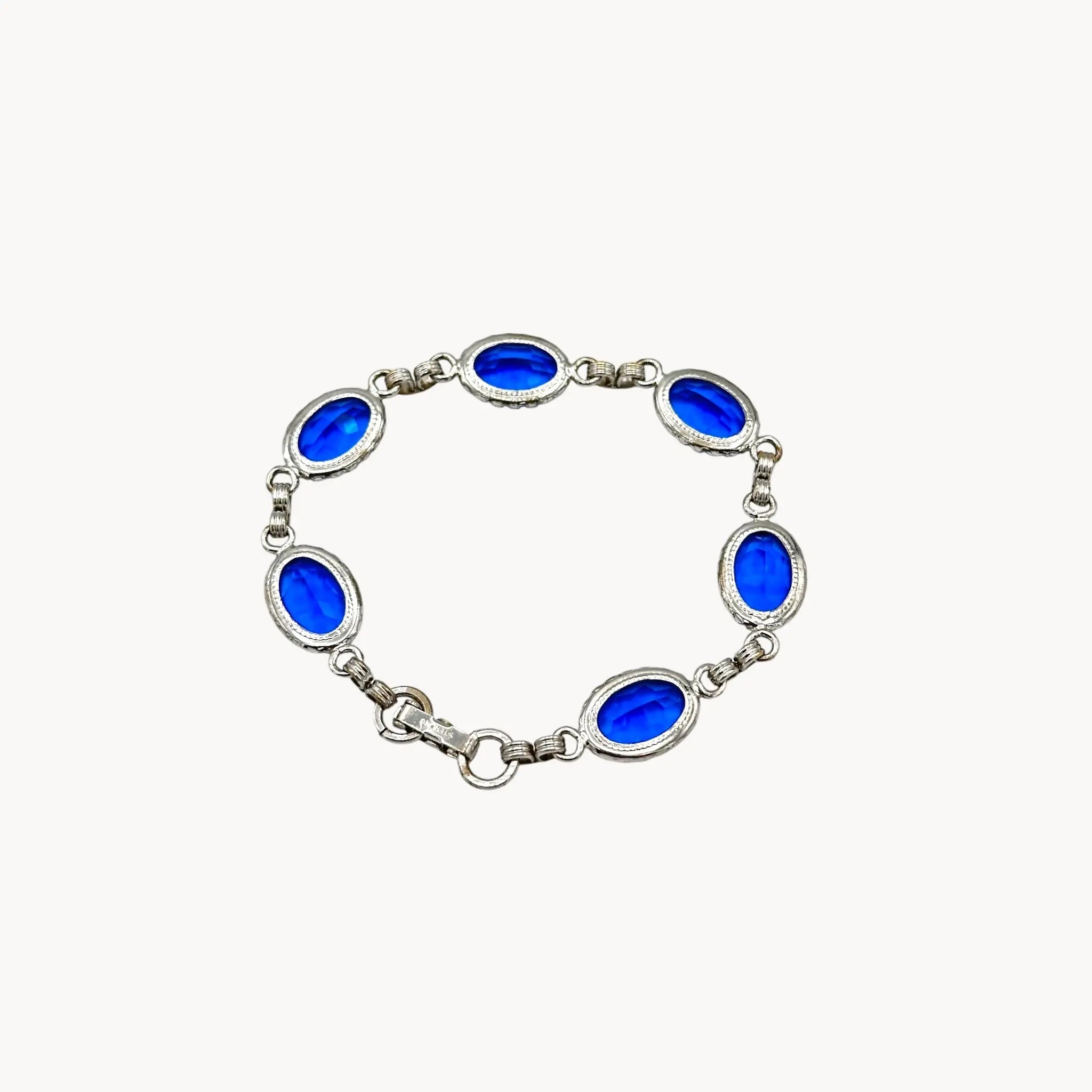 Back view of Vintage sterling silver blue glass link bracelet with oval sapphire-toned stones, mid-century bridal jewelry.