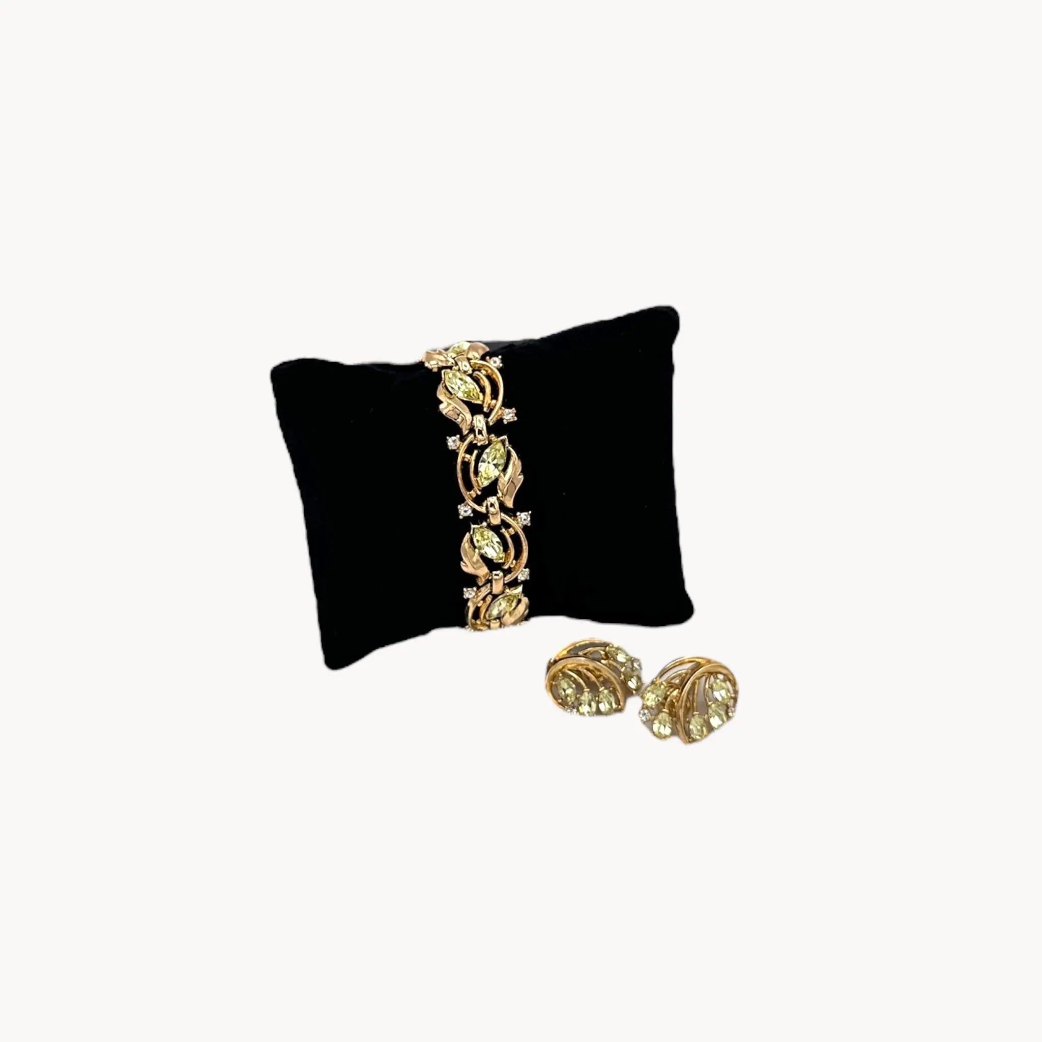 Vintage Trifari bracelet and clip-on earring set with peridot green marquise rhinestones and clear crystal accents, 1950s–1960s jewelry.