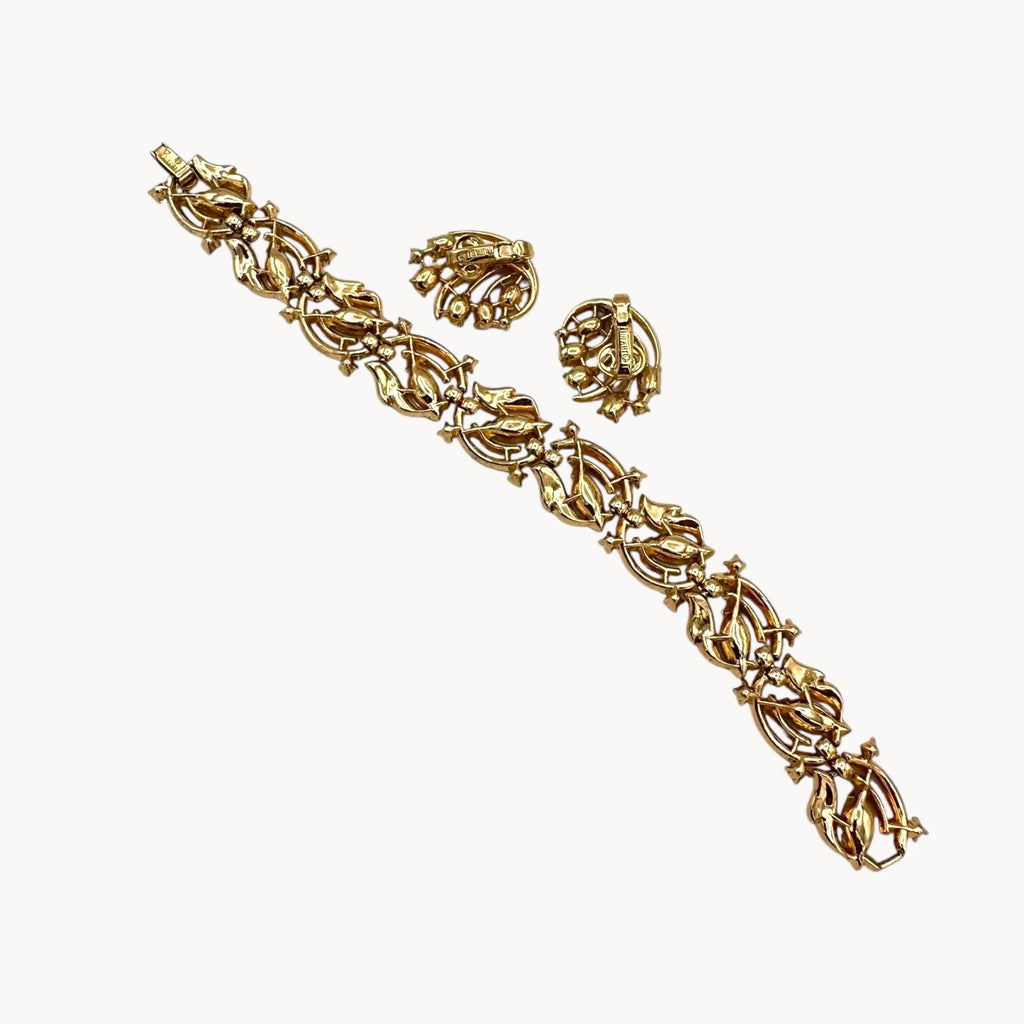 Back view Vintage Trifari bracelet and clip-on earring set with peridot green marquise rhinestones and clear crystal accents, 1950s–1960s jewelry.