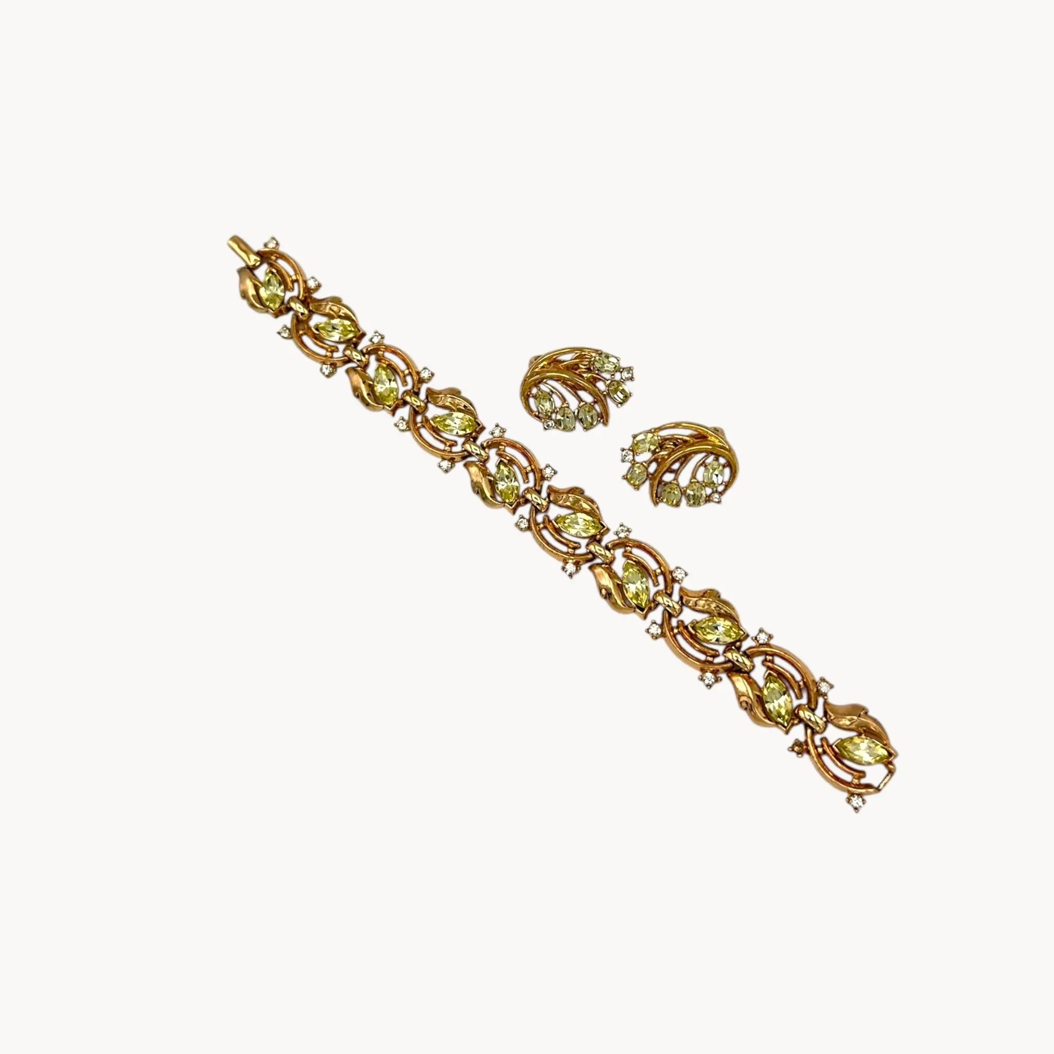 Vintage Trifari bracelet and clip-on earring set with peridot green marquise rhinestones and clear crystal accents, 1950s–1960s jewelry.