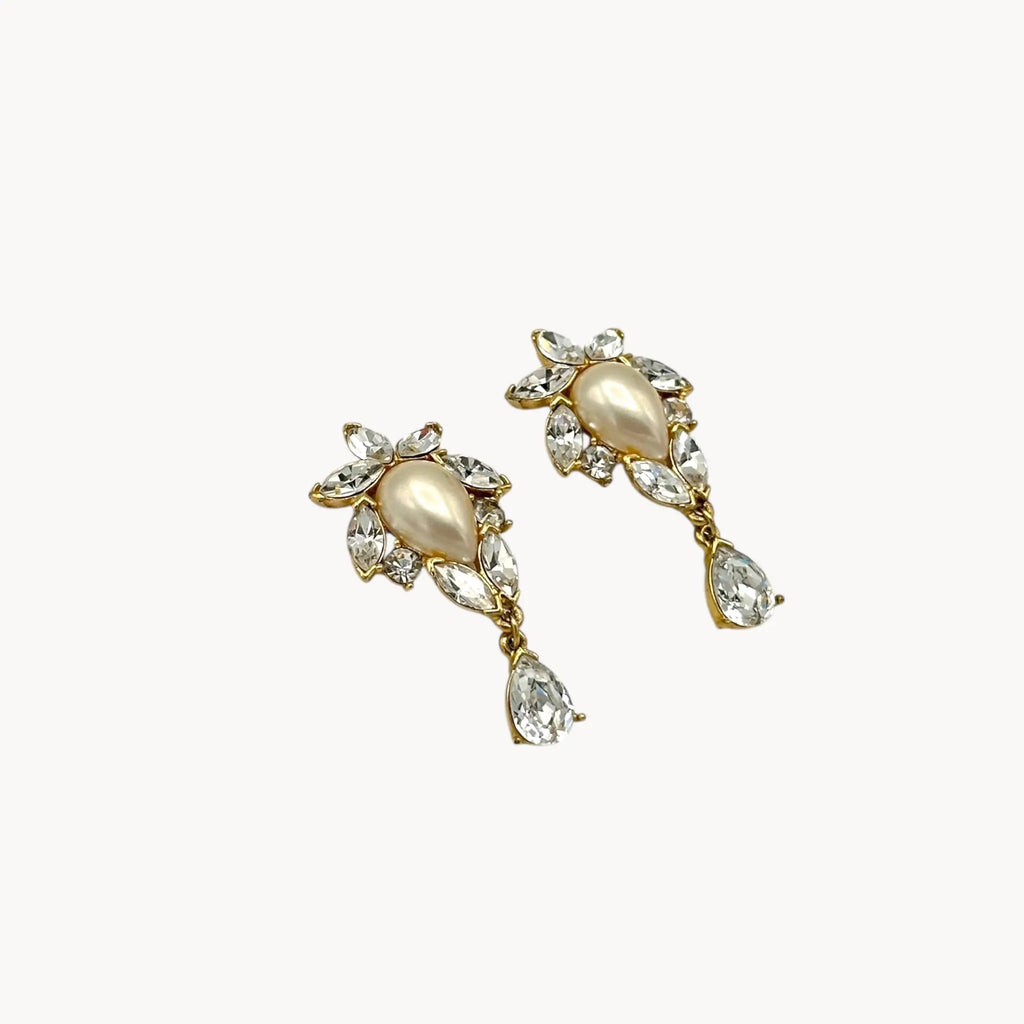 Side view of 1990s Trifari faux pearl and crystal clip-on earrings in gold-tone with teardrop design, vintage bridal jewelry.