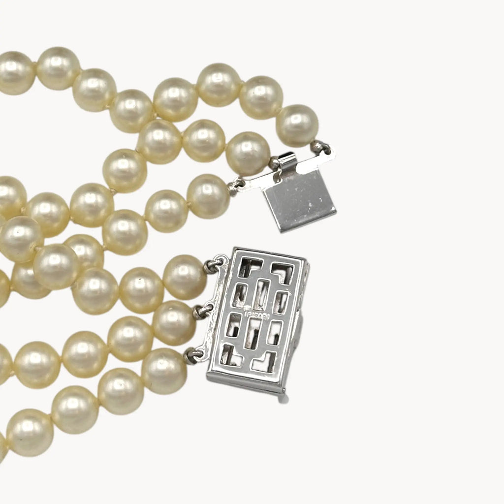 Back view of Vintage Trifari faux pearl triple-strand bracelet with baguette crystal clasp, 1950s–1960s bridal jewelry.