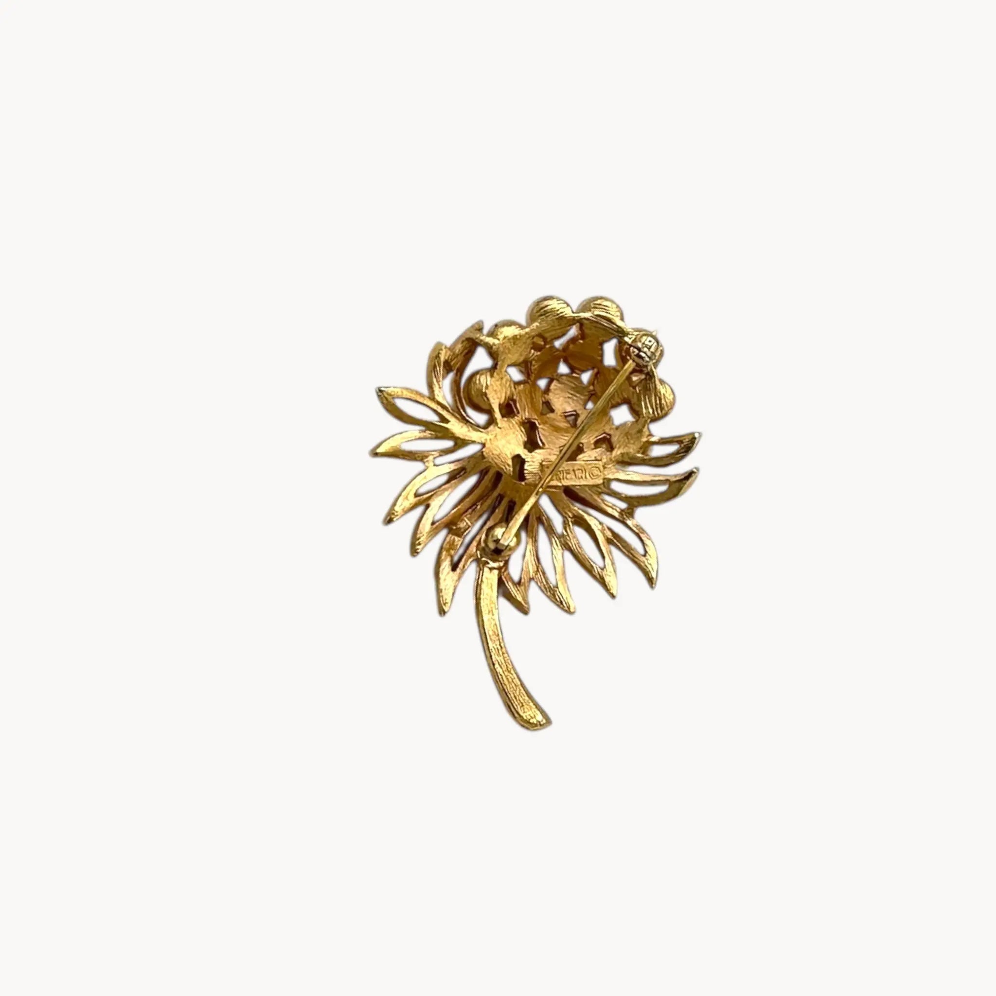 Back view of Vintage Trifari gold tone flower brooch with faux pearl cluster.