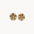 Trifari gold starburst clip-on earrings with faux pearls and rhinestones, 1960s jewelry on white background.