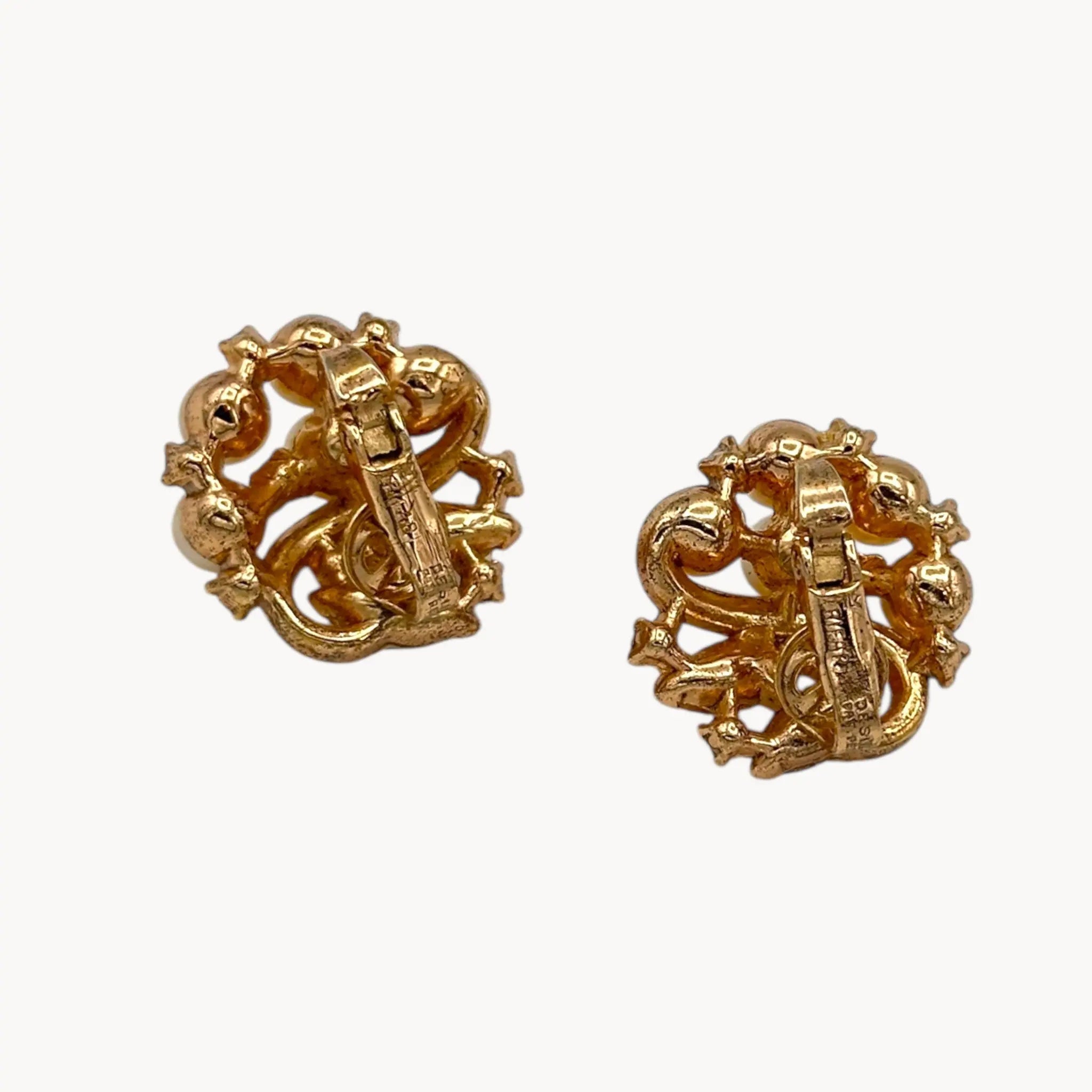 Back of earrings of Brooch of the Vintage Trifari brooch with faux pearls, rhinestones, and gold-tone design shown on white background.