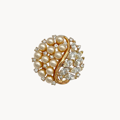 Brooch of the Vintage Trifari brooch with faux pearls, rhinestones, and gold-tone design shown on white background.