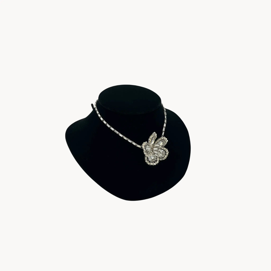 Other side view of Large Trifari Rhinestone Floral Necklace on black bust.