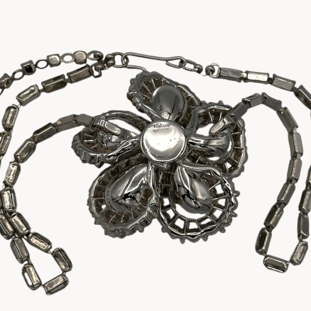 Back view of Large Trifari Rhinestone Floral Necklace on white background.