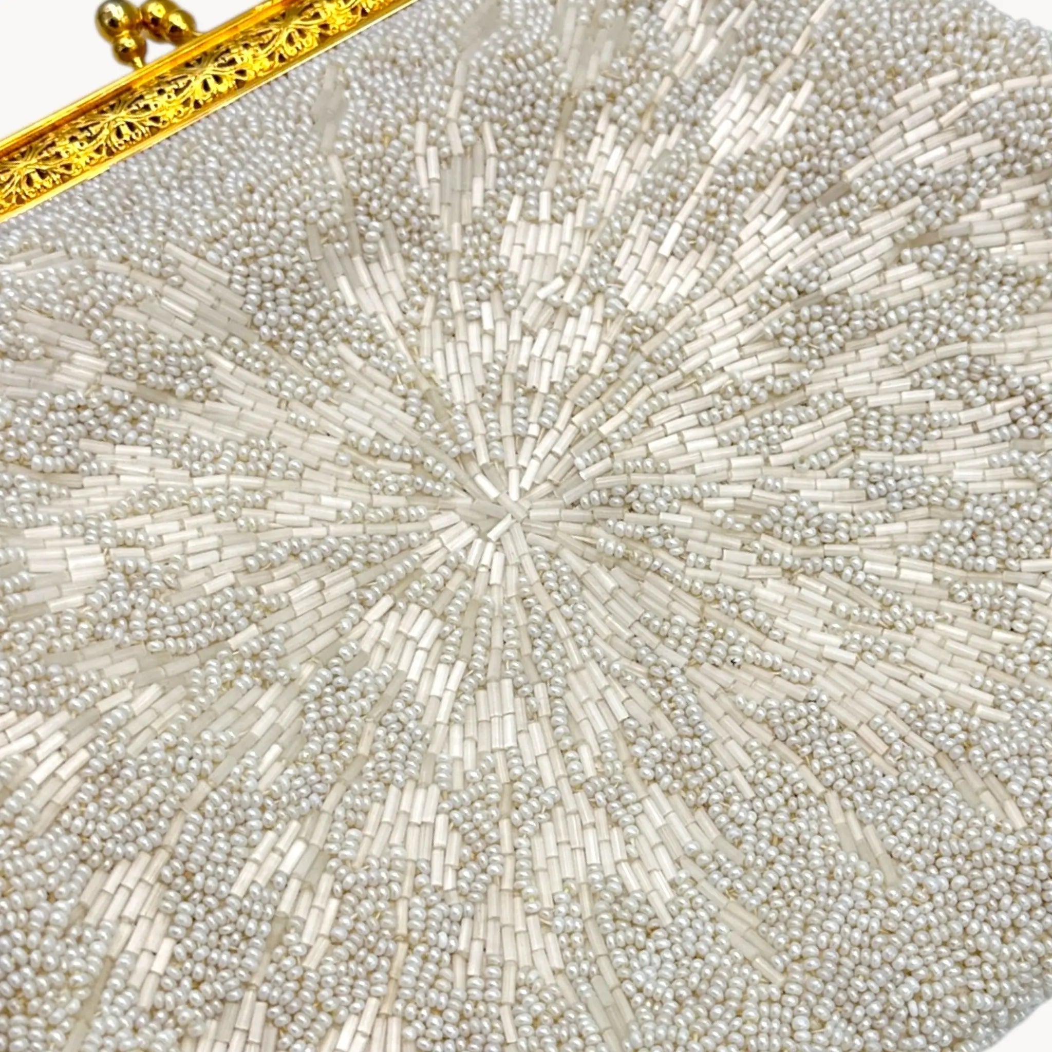 Close-up of a beaded clutch with a gold frame