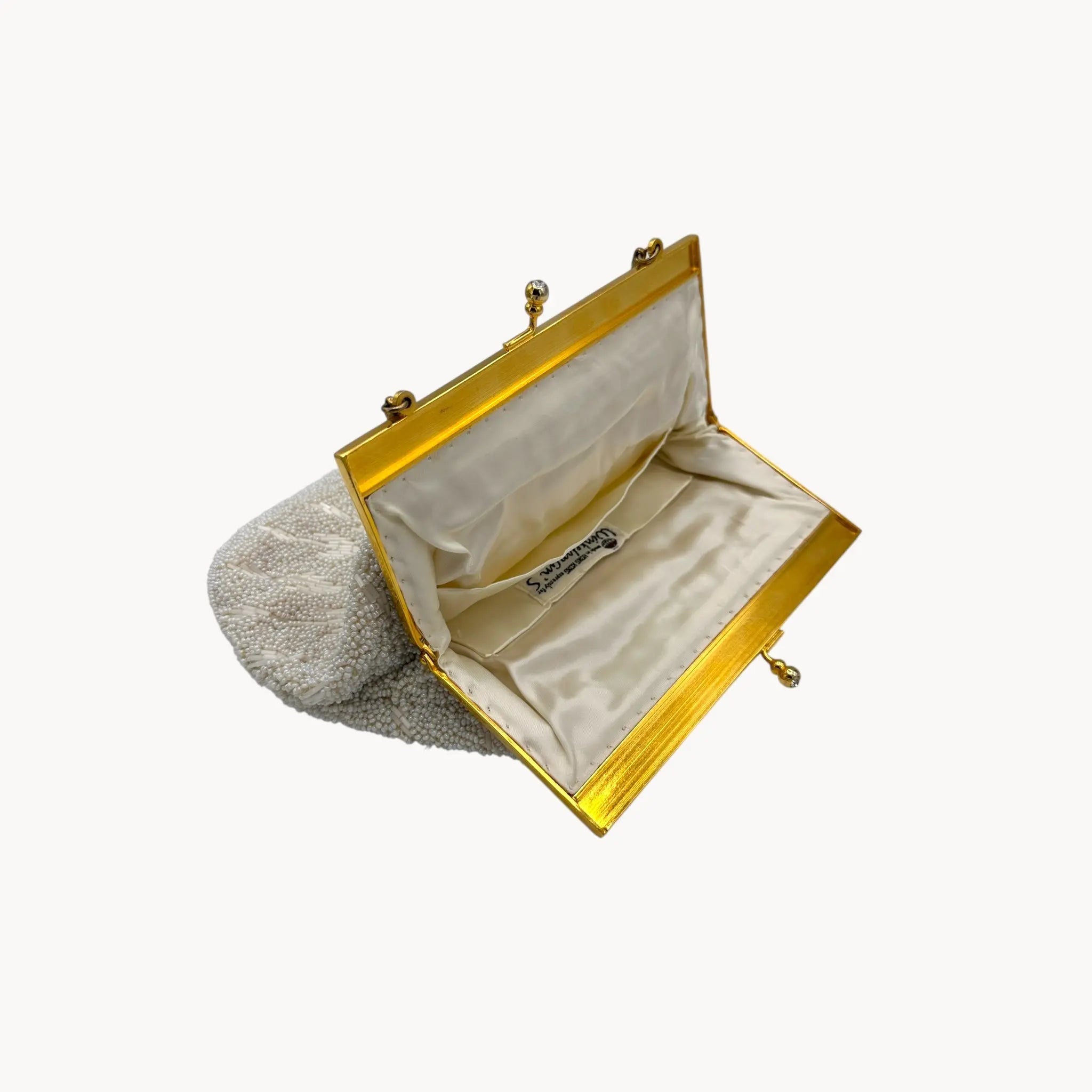 Gold clutch bag with beige interior on a white background