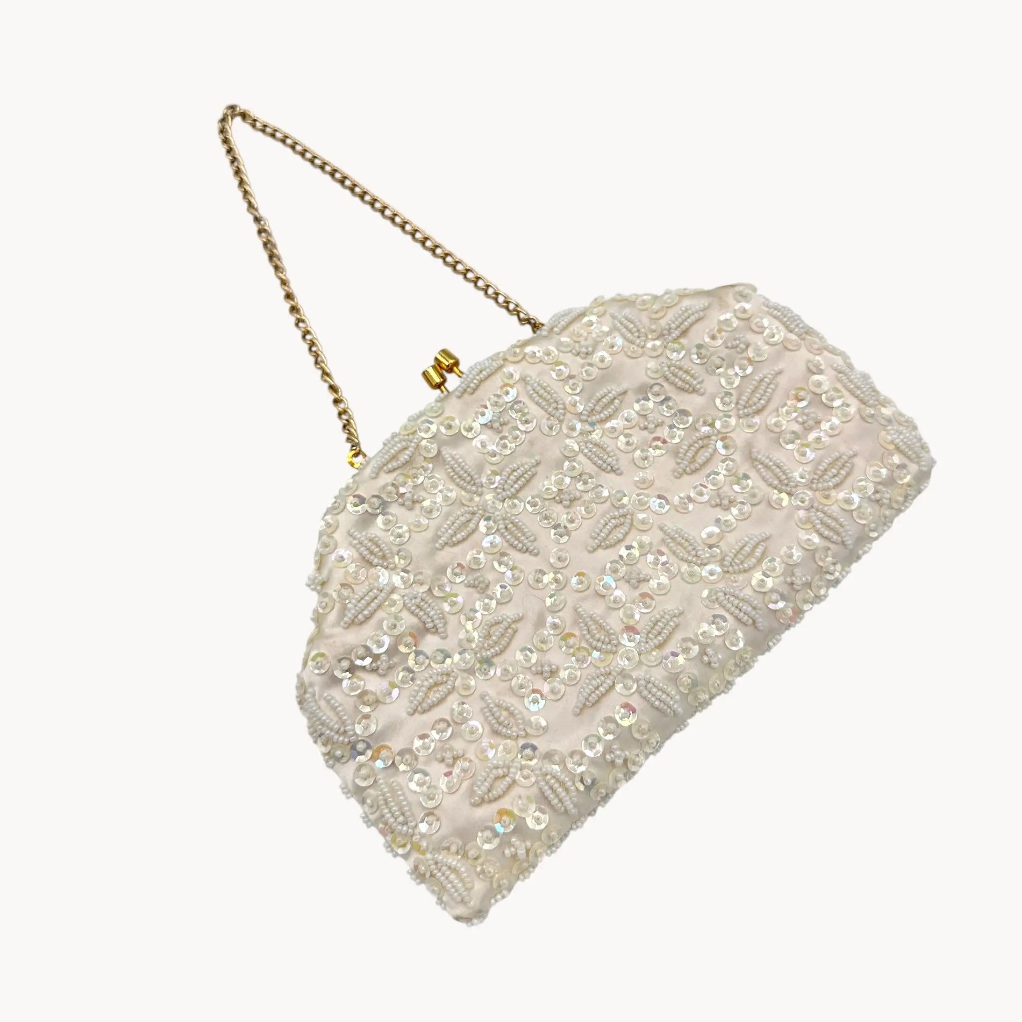 close up view against white background of Vintage white sequined beaded handbag with gold chain handle and kiss-lock clasp