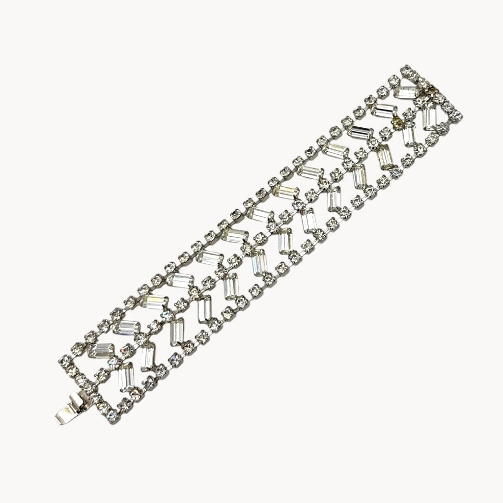 Flat view against white background of Vintage wide rhinestone bracelet with round and baguette-cut stones