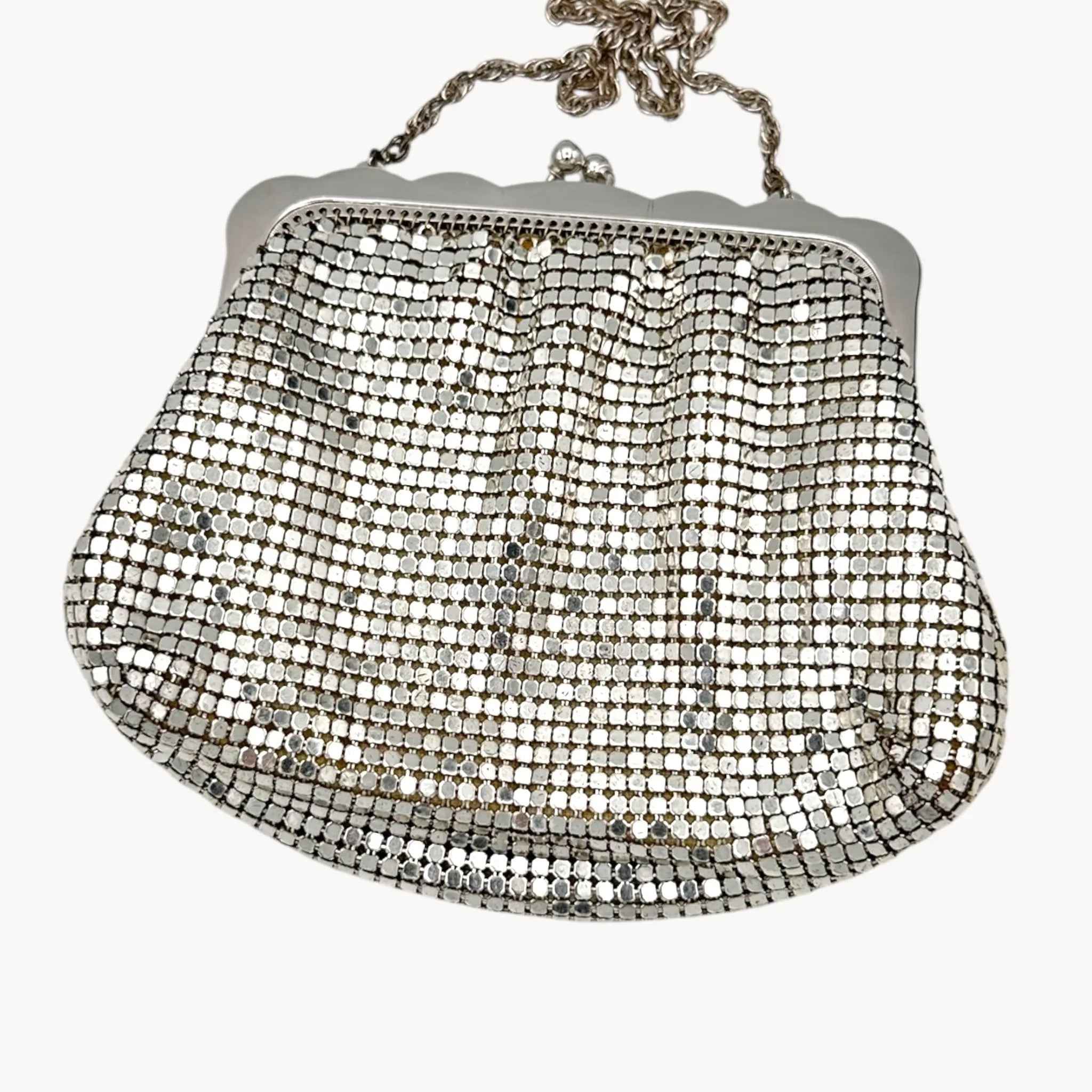 Back view of Whiting & Davis silver mesh petite Art Deco style handbag with chain handle on white background.