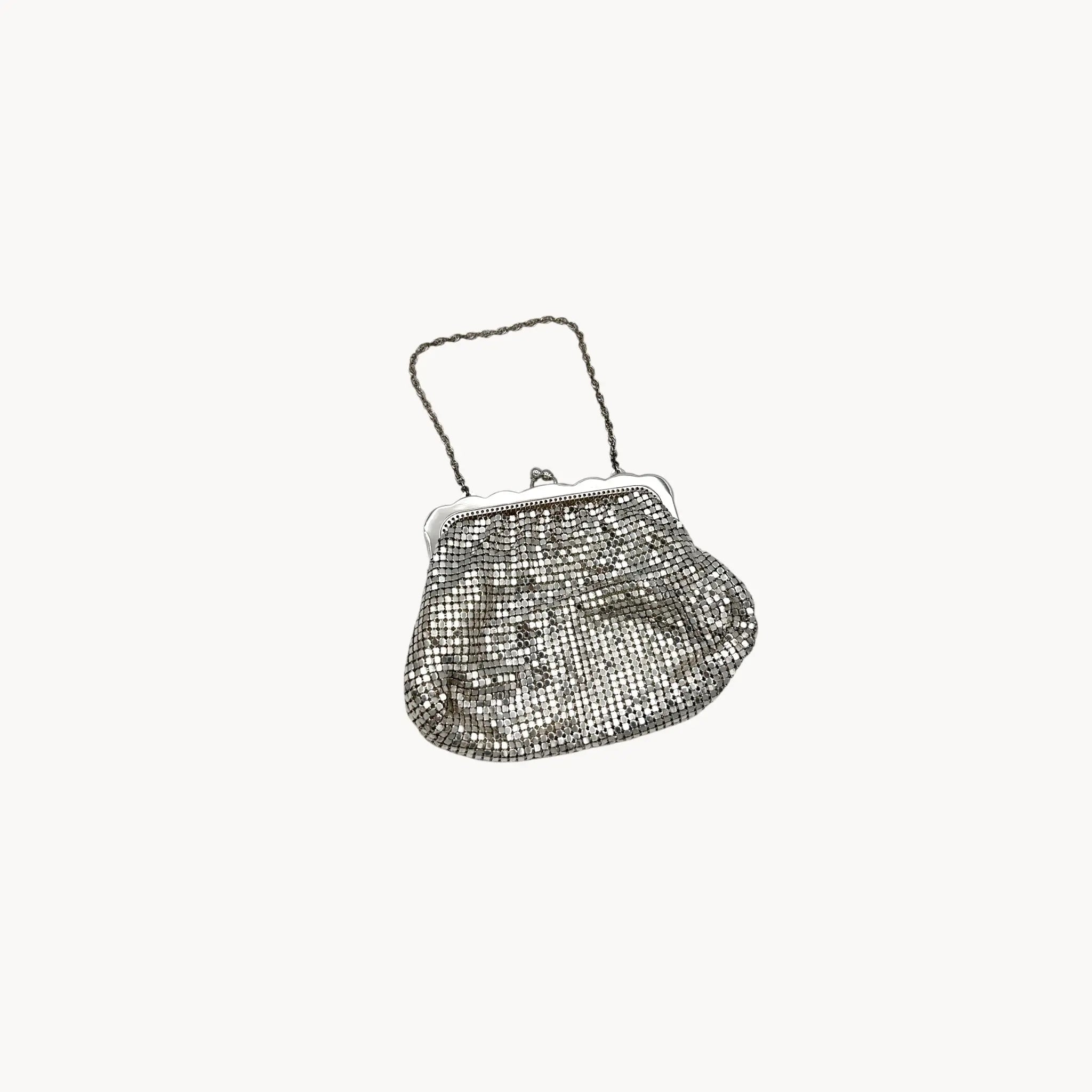 Whiting & Davis silver mesh petite Art Deco style handbag with chain handle on white background.